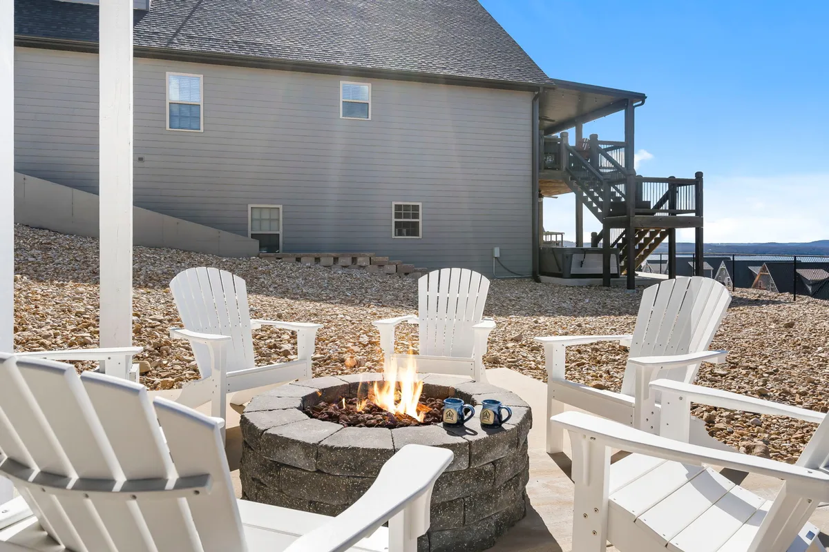 A cozy exterior fire pit area surrounded by Adirondack chairs, coffee mugs in hand, and the golden glow of sunset. The setup invites conversation, storytelling, and bonding under the open sky, echoing the communal, festive spirit described in the section.